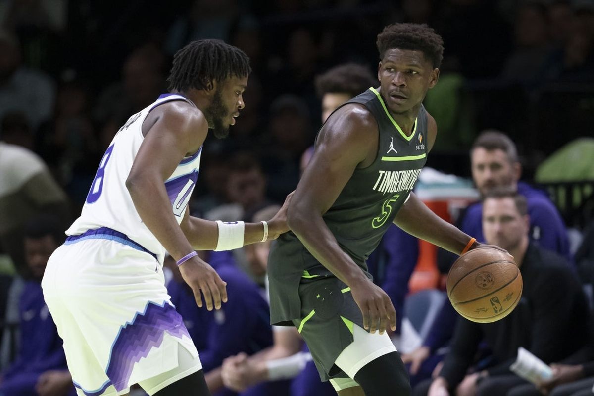 Nov 7, 2025; Minneapolis, Minnesota, USA; Minnesota Timberwolves guard Anthony Edwards (5) dribbles the ball as Utah Jazz guard Isaiah Collier (8) plays defense in the first half at Target Center. Mandatory Credit: Jesse Johnson-Imagn Images