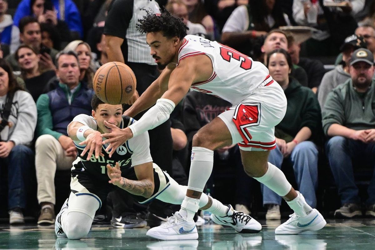 Nov 7, 2025; Milwaukee, Wisconsin, USA;  Milwaukee Bucks guard Ryan Rollins (13) passes the ball away from Chicago Bulls guard Tre Jones (30) in the second quarter at Fiserv Forum. Mandatory Credit: Benny Sieu-Imagn Images