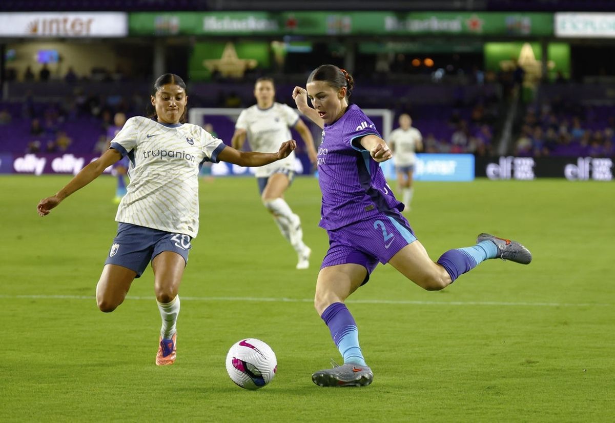 Nov 7, 2025; Orlando, Florida, USA;  Orlando Pride defender Haley McCutcheon (2) attempt to take a shot as Seattle Reign FC midfielder Sam Meza (20) defends in the first half at Inter&Co Stadium. Mandatory Credit: Russell Lansford-Imagn Images