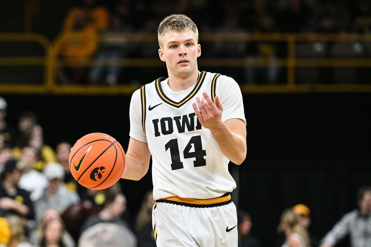 Nov 7, 2025; Iowa City, Iowa, USA; Iowa Hawkeyes guard Bennett Stirtz (14) controls the ball against the Western Illinois Leathernecks during the second half at Carver-Hawkeye Arena. Mandatory Credit: Jeffrey Becker-Imagn Images