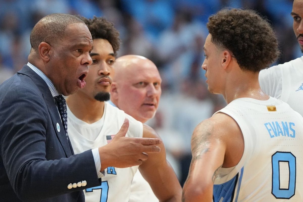 Nov 7, 2025; Chapel Hill, North Carolina, USA; North Carolina Tar Heels head coach Hubert Davis talks with guard Kyan Evans (0) in the second half at Dean E. Smith Center. Mandatory Credit: Bob Donnan-Imagn Images
