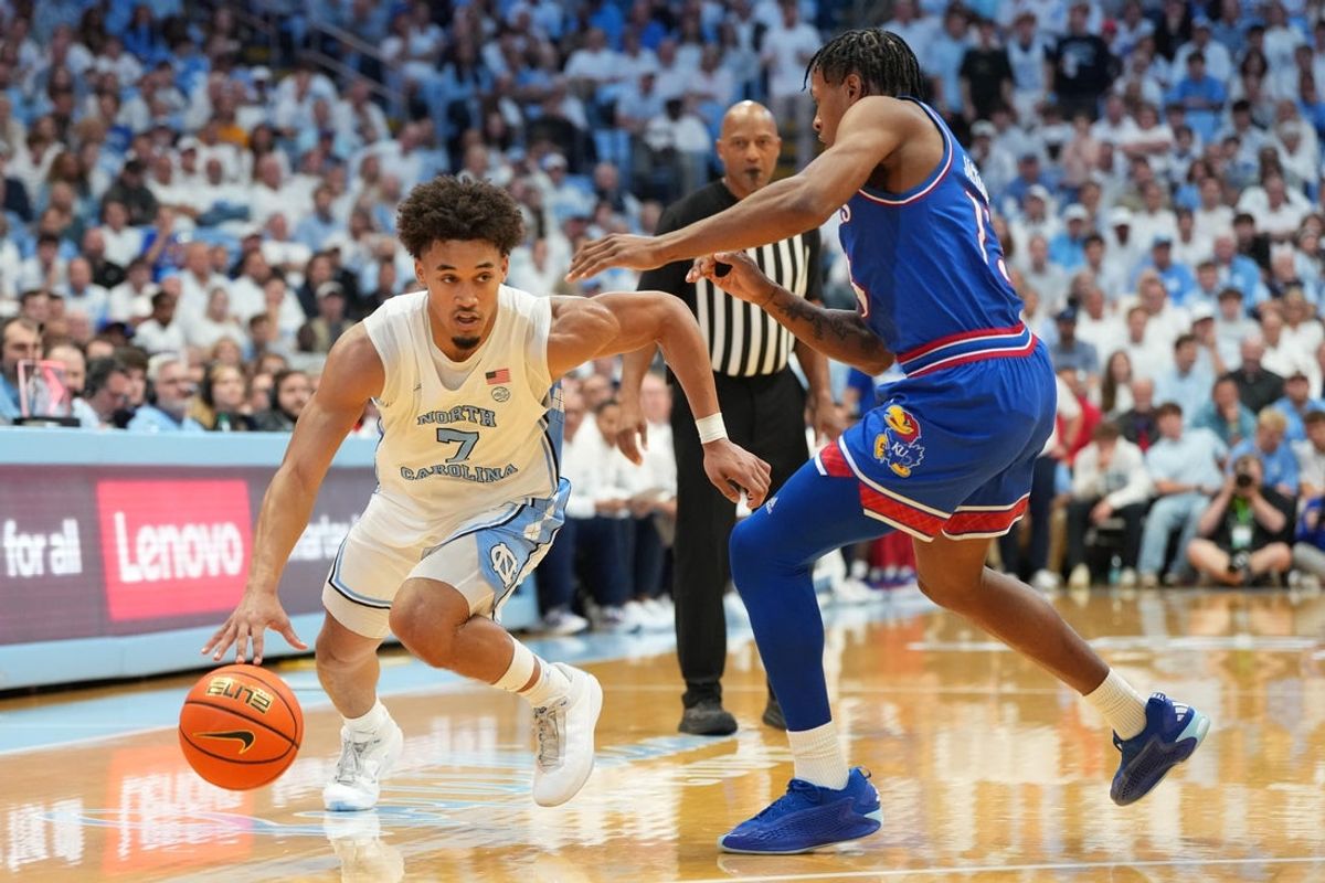 Nov 7, 2025; Chapel Hill, North Carolina, USA;  North Carolina Tar Heels guard Seth Trimble (7) with the ball as Kansas Jayhawks guard Elmarko Jackson (13) defends in the second half at Dean E. Smith Center. Mandatory Credit: Bob Donnan-Imagn Images