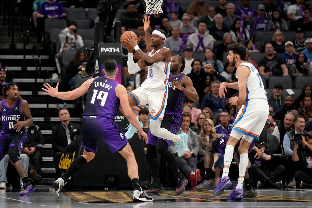 Nov 7, 2025; Sacramento, California, USA; Oklahoma City Thunder guard Shai Gilgeous-Alexander (2) passes the ball around the reach of Sacramento Kings forward Drew Eubanks (19) in the first quarter at the Golden 1 Center. Mandatory Credit: Cary Edmondson-Imagn Images