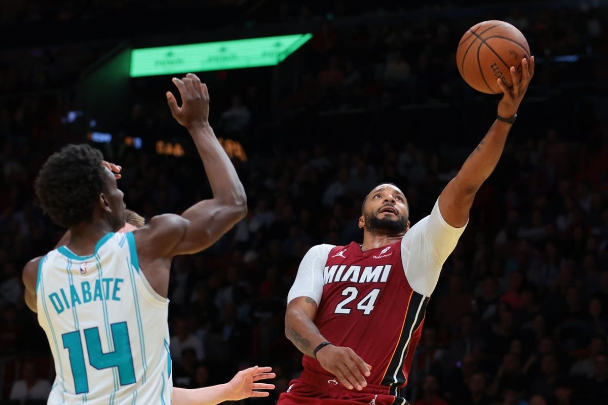 Nov 7, 2025; Miami, Florida, USA; Miami Heat guard Norman Powell (24) lays up a shot against Charlotte Hornets forward Moussa Diabate (14) during the third quarter of an NBA Cup game at Kaseya Center. Mandatory Credit: Sam Navarro-Imagn Images