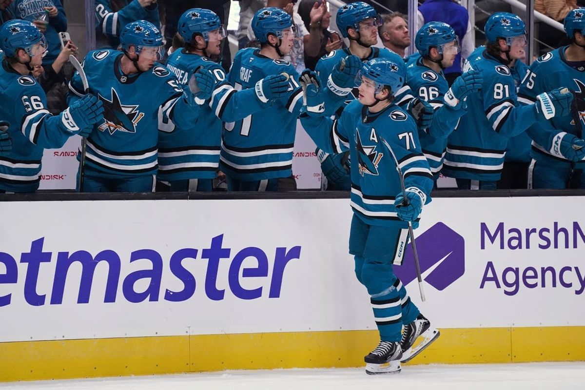 Nov 7, 2025; San Jose, California, USA; San Jose Sharks center Macklin Celebrini (71) shaes hands his teammates on the bench after scoring a goal against the Winnipeg Jets in the first period at SAP Center at San Jose. Mandatory Credit: David Gonzales-Imagn Images