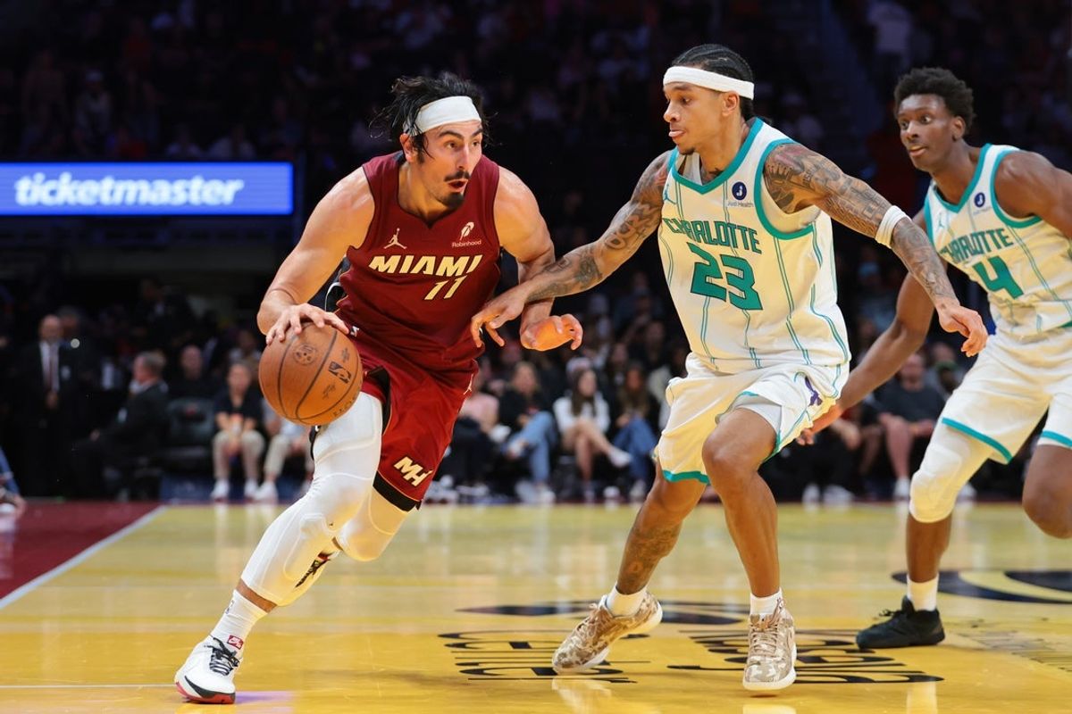 Nov 7, 2025; Miami, Florida, USA; Miami Heat forward Jaime Jaquez Jr. (11) drives to the basket against Charlotte Hornets guard Tre Mann (23) during the fourth quarter of an NBA Cup game at Kaseya Center. Mandatory Credit: Sam Navarro-Imagn Images