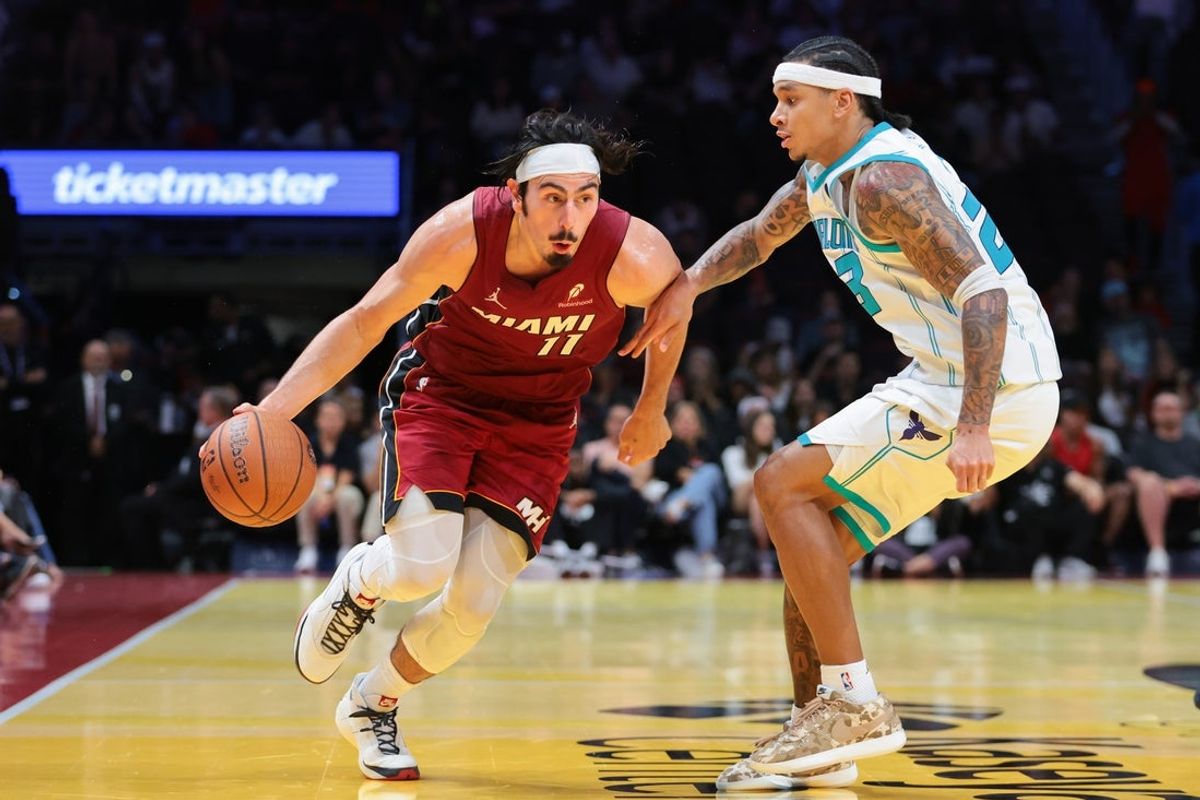 Nov 7, 2025; Miami, Florida, USA; Miami Heat forward Jaime Jaquez Jr. (11) drives to the basket against Charlotte Hornets guard Tre Mann (23) during the fourth quarter of an NBA Cup game at Kaseya Center. Mandatory Credit: Sam Navarro-Imagn Images