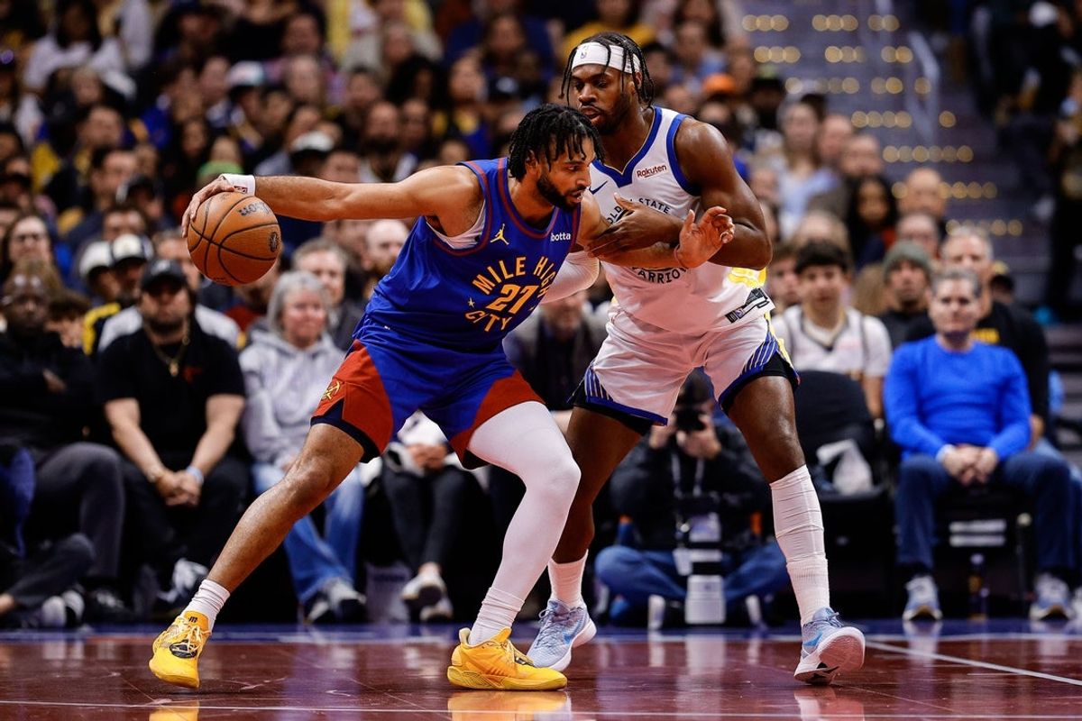 Nov 7, 2025; Denver, Colorado, USA; Denver Nuggets guard Jamal Murray (27) controls the ball under pressure from Golden State Warriors guard Buddy Hield (7) in the second quarter at Ball Arena. Mandatory Credit: Isaiah J. Downing-Imagn Images