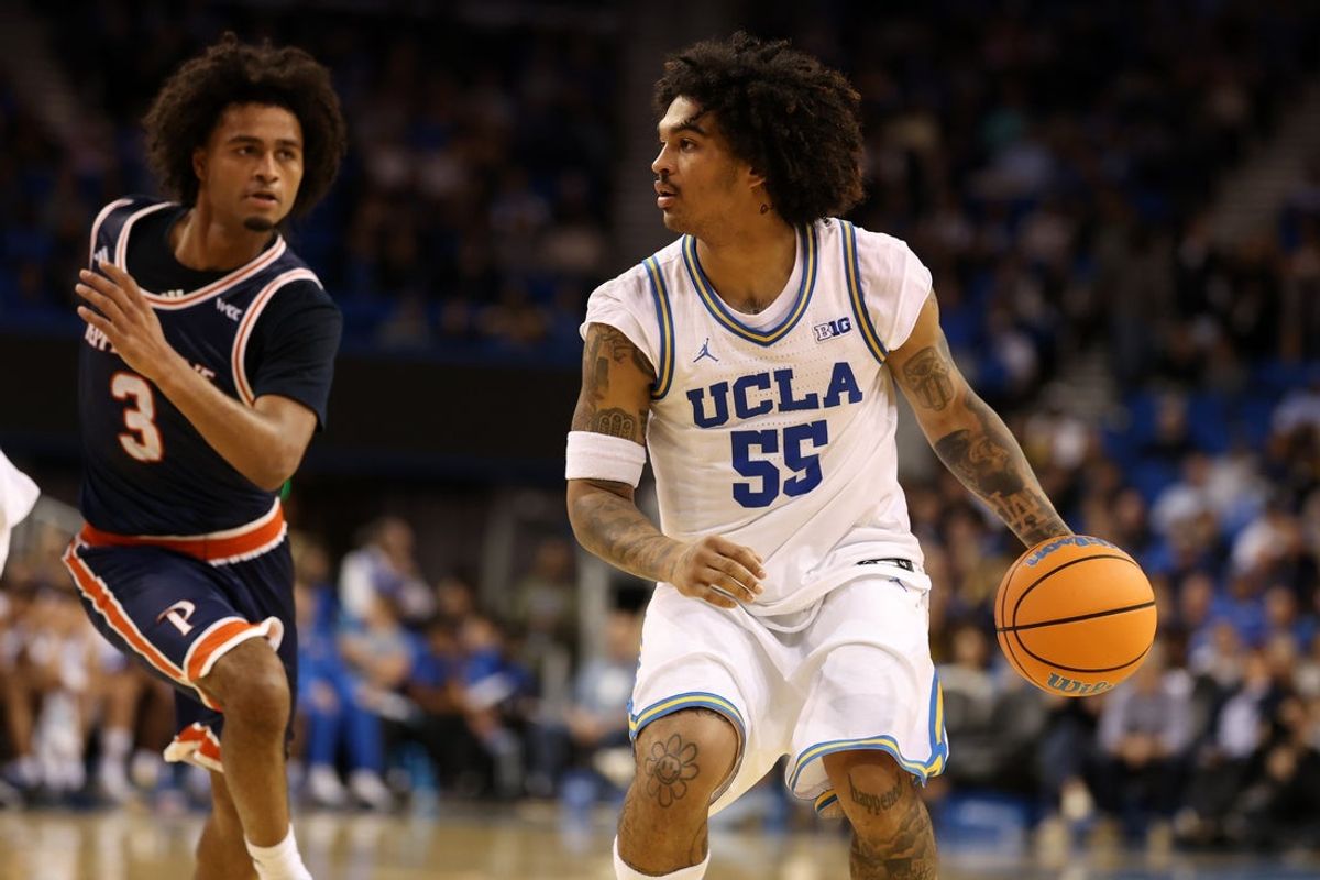 Nov 7, 2025; Los Angeles, California, USA;  UCLA Bruins guard Skyy Clark (55) dribbles the ball against Pepperdine Waves guard Aaron Clark (3) during the first half at Pauley Pavilion presented by Wescom Financial. Mandatory Credit: Kiyoshi Mio-Imagn Images