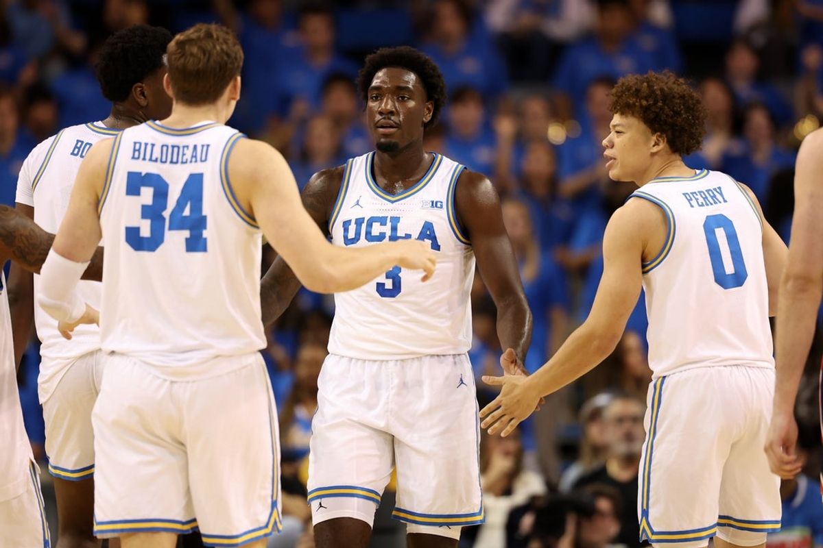 Nov 7, 2025; Los Angeles, California, USA;  UCLA Bruins forward Eric Dailey Jr. (3) is greeted by forward Tyler Bilodeau (34) and guard Trent Perry (0) during the first half against the Pepperdine Waves at Pauley Pavilion presented by Wescom Financial. Mandatory Credit: Kiyoshi Mio-Imagn Images