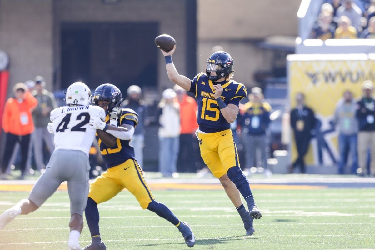 Nov 8, 2025; Morgantown, West Virginia, USA; West Virginia Mountaineers quarterback Scotty Fox Jr. (15) throws a pass during the first quarter against the Colorado Buffaloes at Milan Puskar Stadium. Mandatory Credit: Ben Queen-Imagn Images