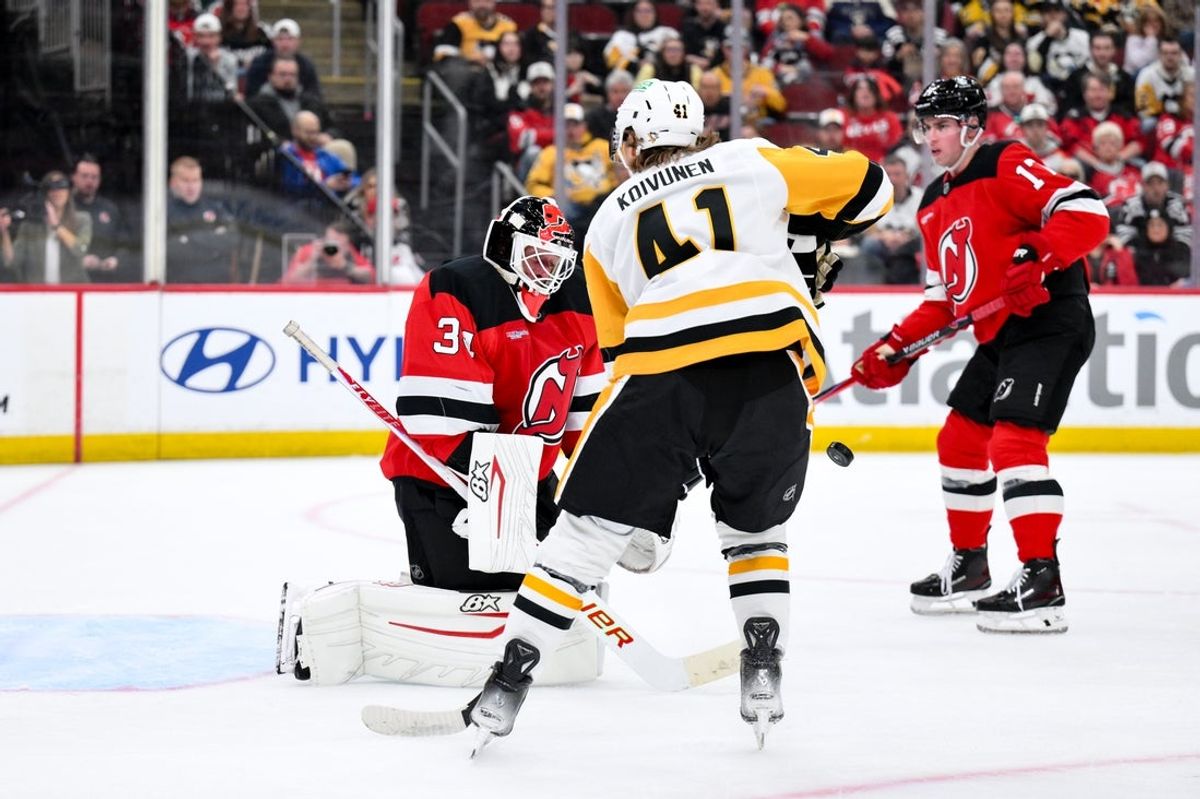 Nov 8, 2025; Newark, New Jersey, USA; New Jersey Devils goaltender Jake Allen (34) makes a save against the Pittsburgh Penguins during the first period at Prudential Center. Mandatory Credit: John Jones-Imagn Images