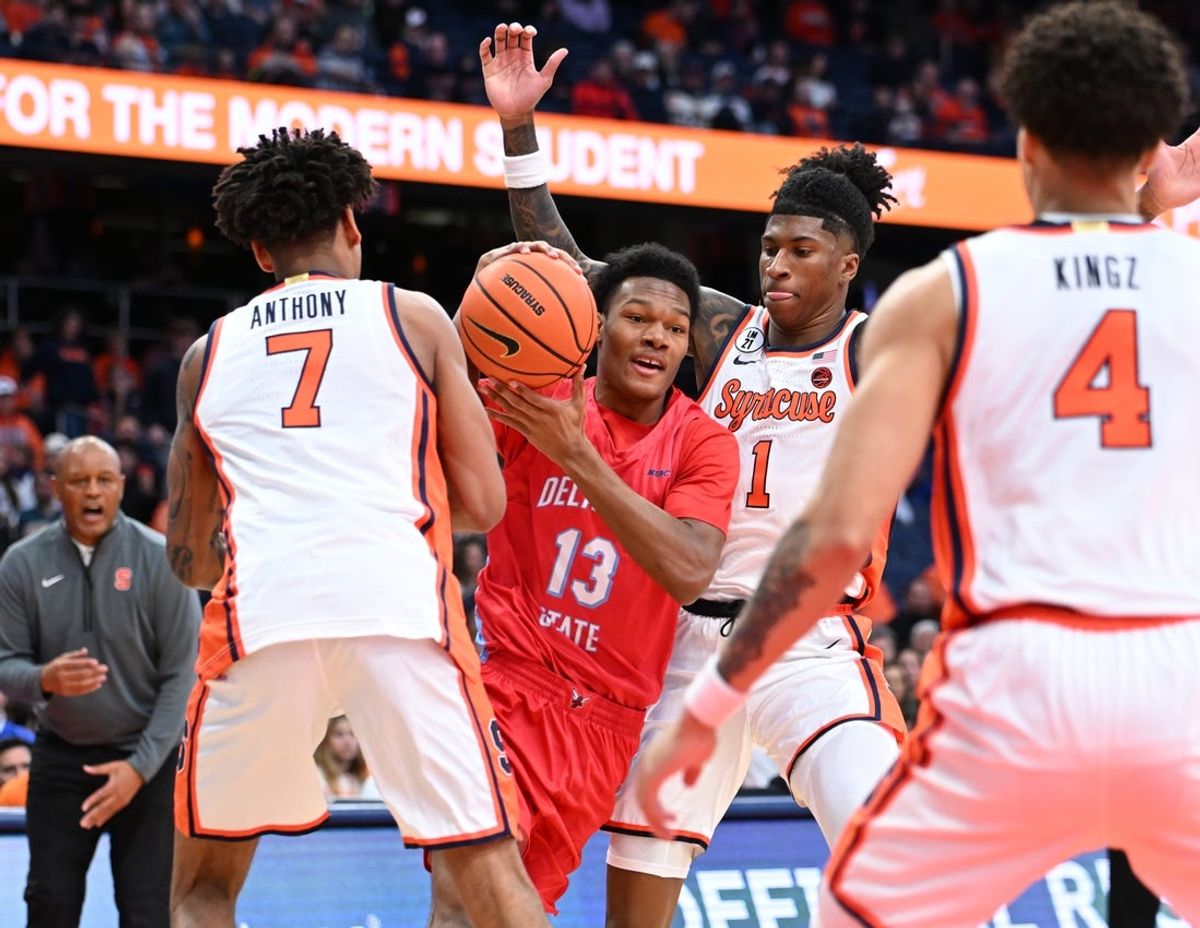 Nov 8, 2025; Syracuse, New York, USA; Delaware State Hornets guard Kareem Watson (13) is surrounded by Syracuse Orange defenders forward Kiyan Anthony (7), forward Donnie Freeman (1), and guard Nate Kingz (4) in the first half at the JMA Wireless Dome. Mandatory Credit: Mark Konezny-Imagn Images
