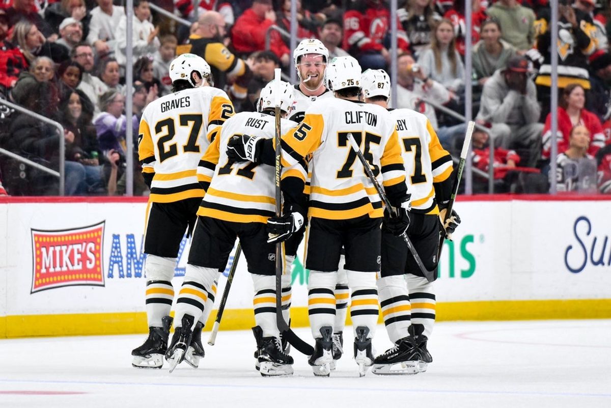 Nov 8, 2025; Newark, New Jersey, USA; Pittsburgh Penguins defenseman Ryan Graves (27) celebrates with teammates after scoring a goal against the New Jersey Devils during the second period at Prudential Center. Mandatory Credit: John Jones-Imagn Images