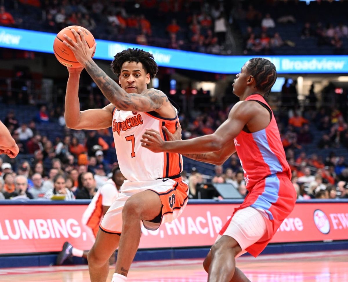 Nov 8, 2025; Syracuse, New York, USA; Syracuse Orange forward Kiyan Anthony (7) drives the ball past Delaware State Hornets guard Jalen Stclair (8) in the second half at the JMA Wireless Dome. Mandatory Credit: Mark Konezny-Imagn Images