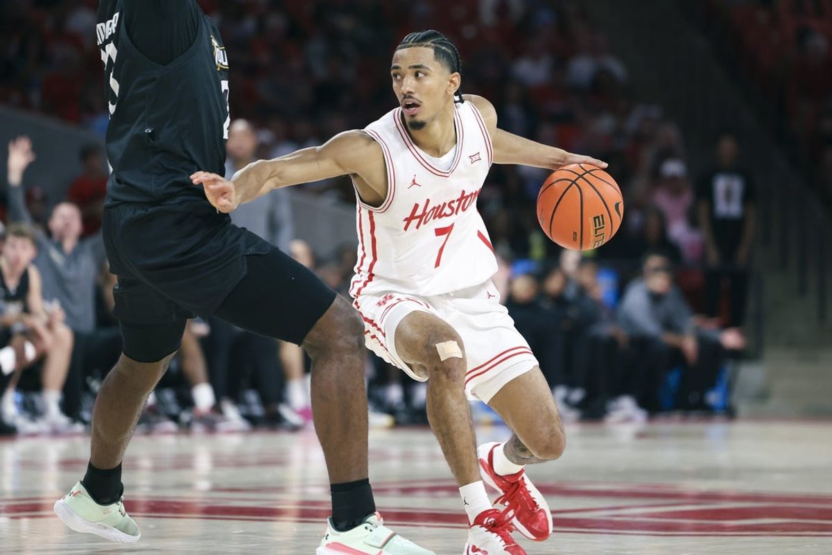 Nov 8, 2025; Houston, Texas, USA; Houston Cougars guard Milos Uzan (7) controls the ball during the second half against the Towson Tigers at Fertitta Center. Mandatory Credit: Troy Taormina-Imagn Images