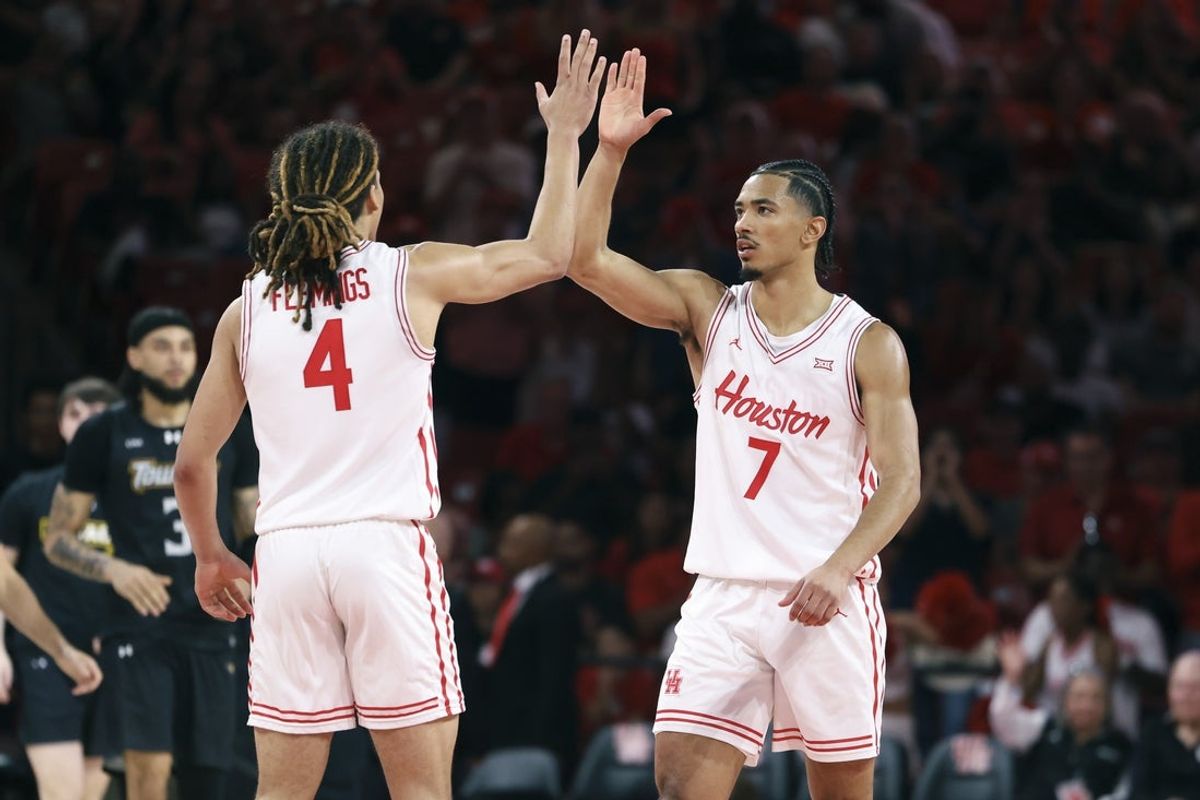 Nov 8, 2025; Houston, Texas, USA; Houston Cougars guard Milos Uzan (7) celebrates with guard Kingston Flemings (4) after a play during the second half against the Towson Tigers at Fertitta Center. Mandatory Credit: Troy Taormina-Imagn Images