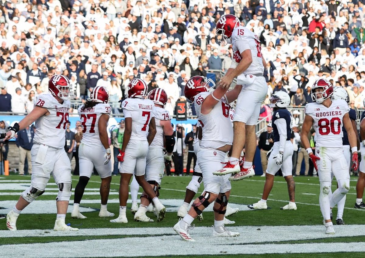 Nov 8, 2025; University Park, Pennsylvania, USA; Indiana Hoosiers quarterback Fernando Mendoza (15) is lifted into the air after throwing a touchdown pass to wide receiver Omar Cooper Jr. (3) (not pictured) during the fourth quarter against the Penn State Nittany Lions at Beaver Stadium. Mandatory Credit: Matthew O'Haren-Imagn Images