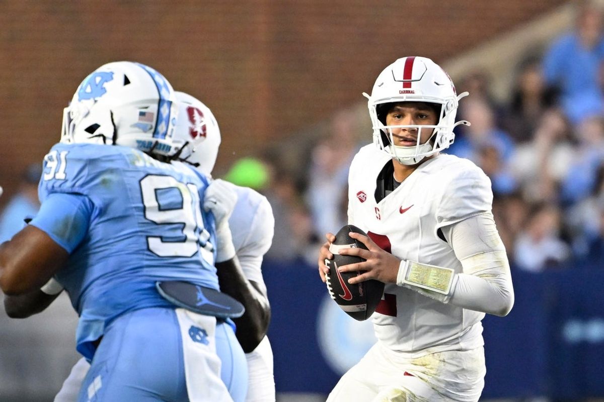 Nov 8, 2025; Chapel Hill, North Carolina, USA; Stanford Cardinal quarterback Elijah Brown (2) looks to pass as North Carolina Tar Heels defensive lineman Leroy Jackson (91) defends in the first quarter at Kenan Stadium. Mandatory Credit: Bob Donnan-Imagn Images