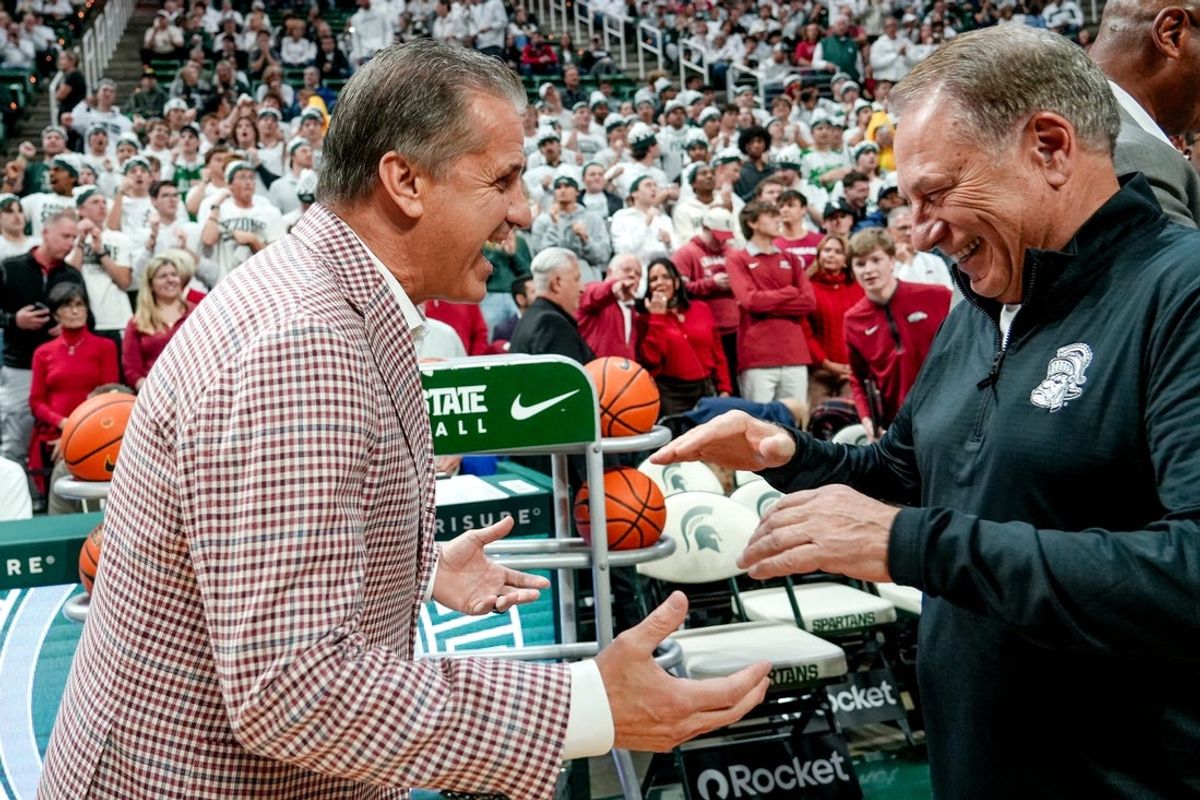 Arkansas' head coach John Calipari, left, and Michigan State's coach Tom Izzo meet before the game on Saturday, Nov. 8, 2025, at the Breslin Center in East Lansing.