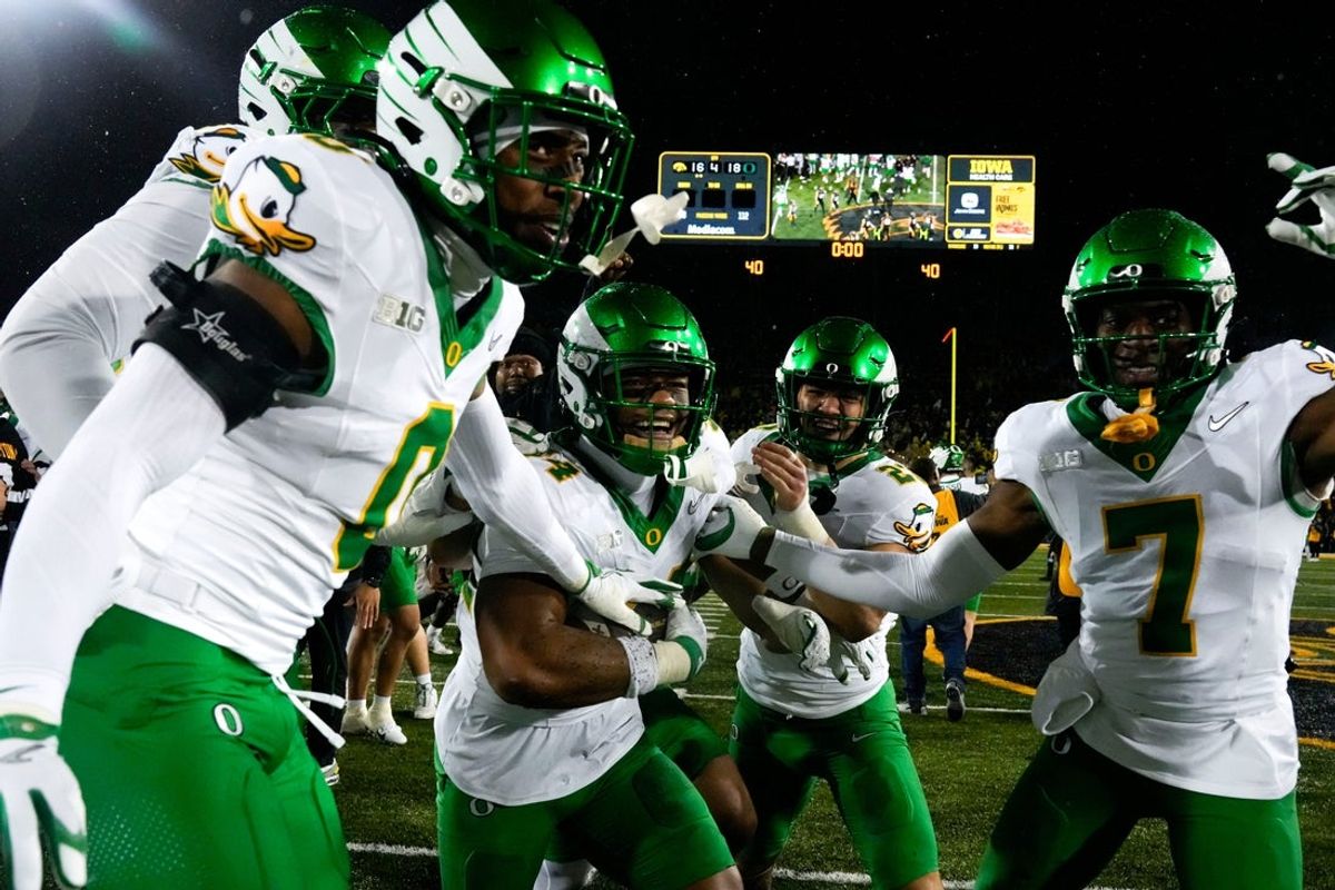 The Oregon Ducks celebrate after defeating the Iowa Hawkeyes Nov. 8, 2025 during a Big Ten Football game at Kinnick Stadium in Iowa City, Iowa.