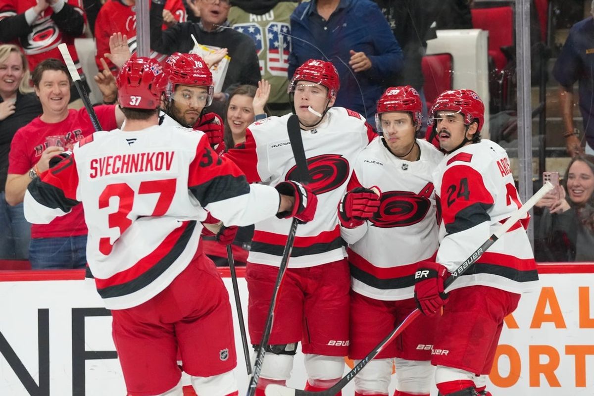 Nov 8, 2025; Raleigh, North Carolina, USA; Carolina Hurricanes center Sebastian Aho (20) celebrates his goal with center Seth Jarvis (24)  defenseman Alexander Nikishin (21) defenseman K'Andre Miller (19) and right wing Andrei Svechnikov (37) against the Buffalo Sabres during the first period at Lenovo Center. Mandatory Credit: James Guillory-Imagn Images
