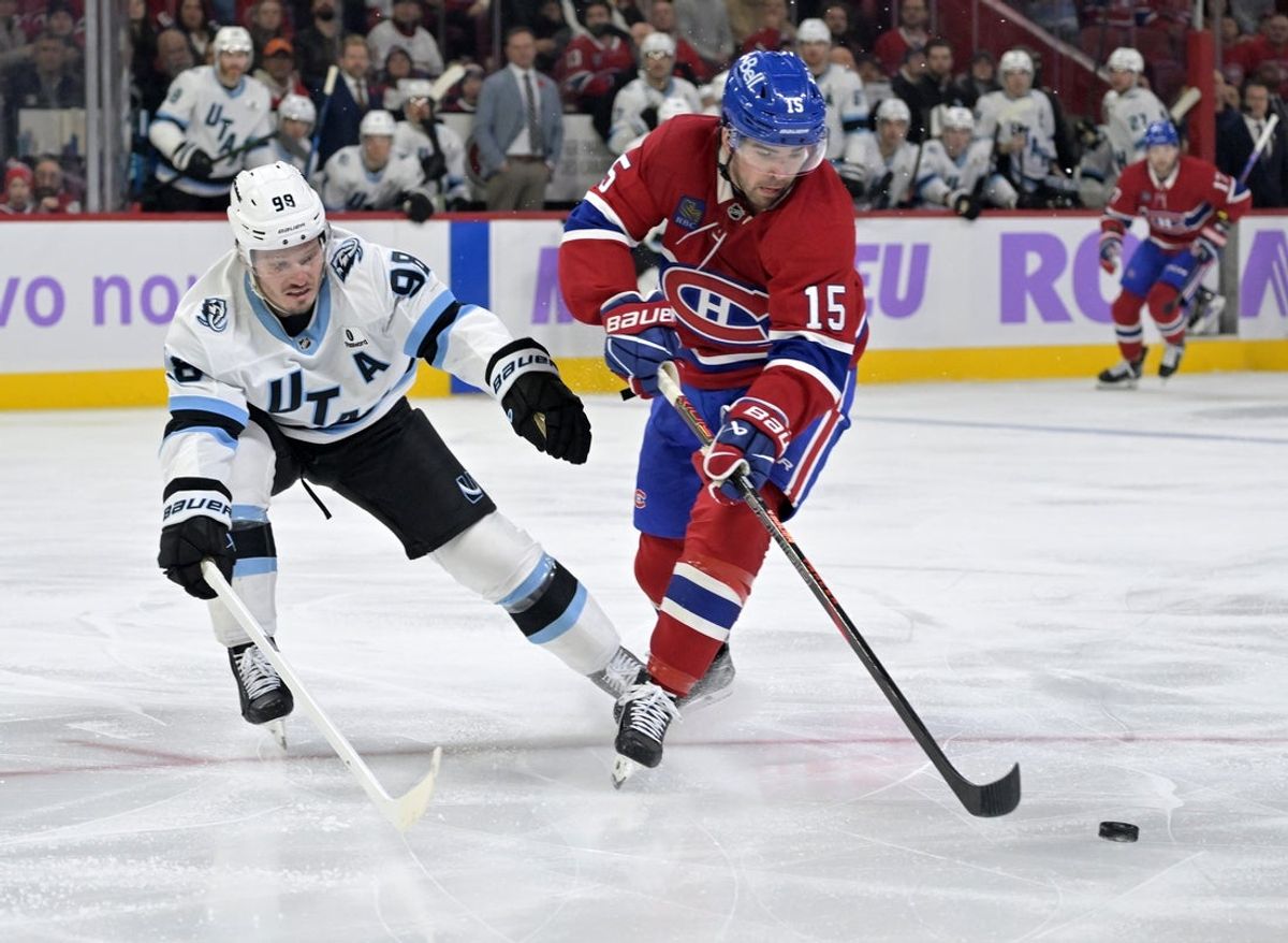 Nov 8, 2025; Montreal, Quebec, CAN; Montreal Canadiens forward Alex Newhook (15) plays the puck and Utah Mammoth defenseman Mikhail Sergachev (98) defends during the first period at the Bell Centre. Mandatory Credit: Eric Bolte-Imagn Images