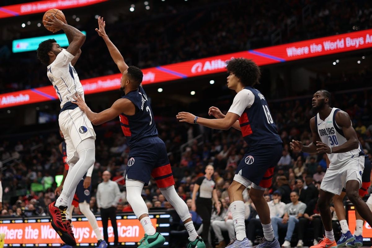 Nov 8, 2025; Washington, District of Columbia, USA; Dallas Mavericks forward Naji Marshall (13) shoots the ball as Washington Wizards guard CJ McCollum (3) defends in the first half at Capital One Arena. Mandatory Credit: Geoff Burke-Imagn Images