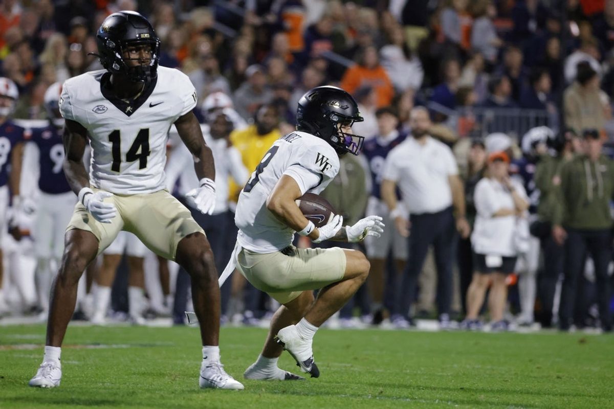 Nov 8, 2025; Charlottesville, Virginia, USA; Wake Forest Demon Deacons wide receiver Carlos Hernandez (8) carries the ball to score a touchdown on a punt return against the Virginia Cavaliers during the first half at Scott Stadium. Mandatory Credit: Amber Searls-Imagn Images