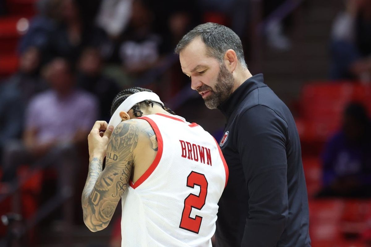 Nov 8, 2025; Salt Lake City, Utah, USA; Utah Utes head coach Alex Jensen speaks with guard Terrence Brown (2) during a break in the second half of a game against the Weber State Wildcats at Jon M. Huntsman Center. Mandatory Credit: Rob Gray-Imagn Images