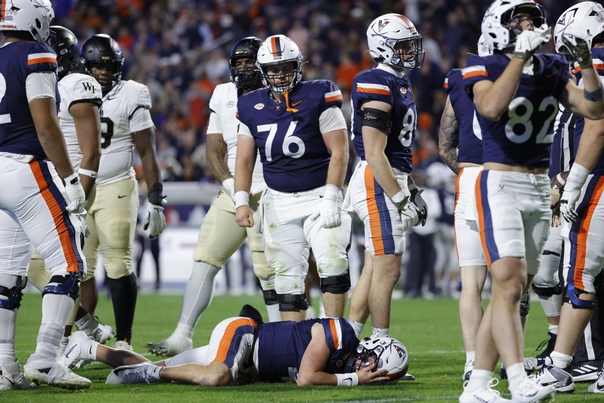 Nov 8, 2025; Charlottesville, Virginia, USA; Virginia Cavaliers quarterback Chandler Morris (4) lays on the field after being injected against the Wake Forest Demon Deacons during the first half at Scott Stadium. Mandatory Credit: Amber Searls-Imagn Images