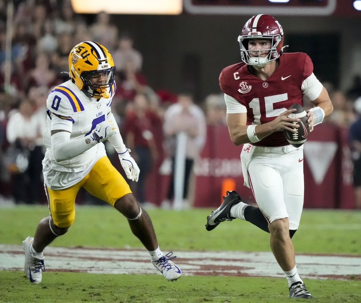 Nov 8, 2025; Tuscaloosa, Alabama, USA;  Alabama quarterback Ty Simpson (15) rolls away from pressure by LSU safety Tamarcus Cooley (0) at Saban Field at Bryant-Denny Stadium. Mandatory Credit: Gary Cosby Jr.-Imagn Images