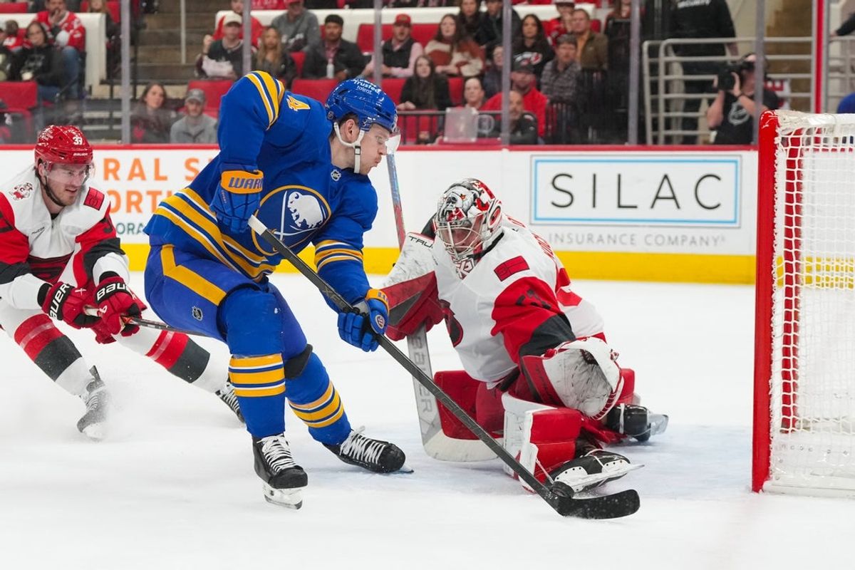 Nov 8, 2025; Raleigh, North Carolina, USA;  Carolina Hurricanes goaltender Pyotr Kochetkov (52) stops the scoring attempt by Buffalo Sabres defenseman Bowen Byram (4) during the second period at Lenovo Center. Mandatory Credit: James Guillory-Imagn Images
