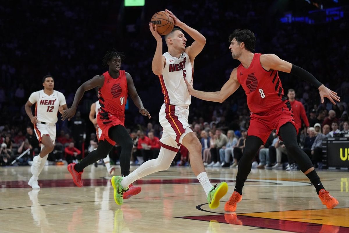 Nov 8, 2025; Miami, Florida, USA;  Miami Heat forward Nikola Jovic (5) drives to the basket as Portland Trail Blazers forward Deni Avdija (8) defends in the first quarter at Kaseya Center. Mandatory Credit: Jim Rassol-Imagn Images