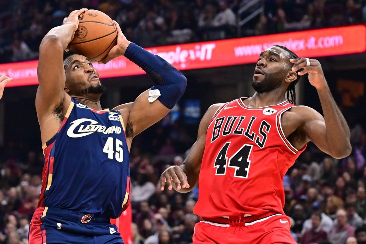 Nov 8, 2025; Cleveland, Ohio, USA; Cleveland Cavaliers guard Donovan Mitchell (45) drives to the basket against Chicago Bulls forward Patrick Williams (44) during the first half at Rocket Arena. Mandatory Credit: Ken Blaze-Imagn Images