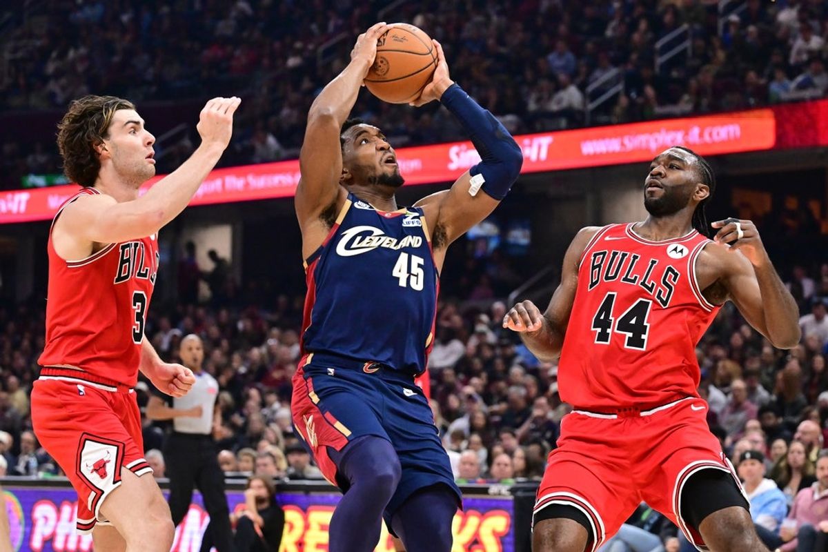 Nov 8, 2025; Cleveland, Ohio, USA; Cleveland Cavaliers guard Donovan Mitchell (45) drives to the basket against Chicago Bulls forward Patrick Williams (44) and guard Josh Giddey (3) during the first half at Rocket Arena. Mandatory Credit: Ken Blaze-Imagn Images