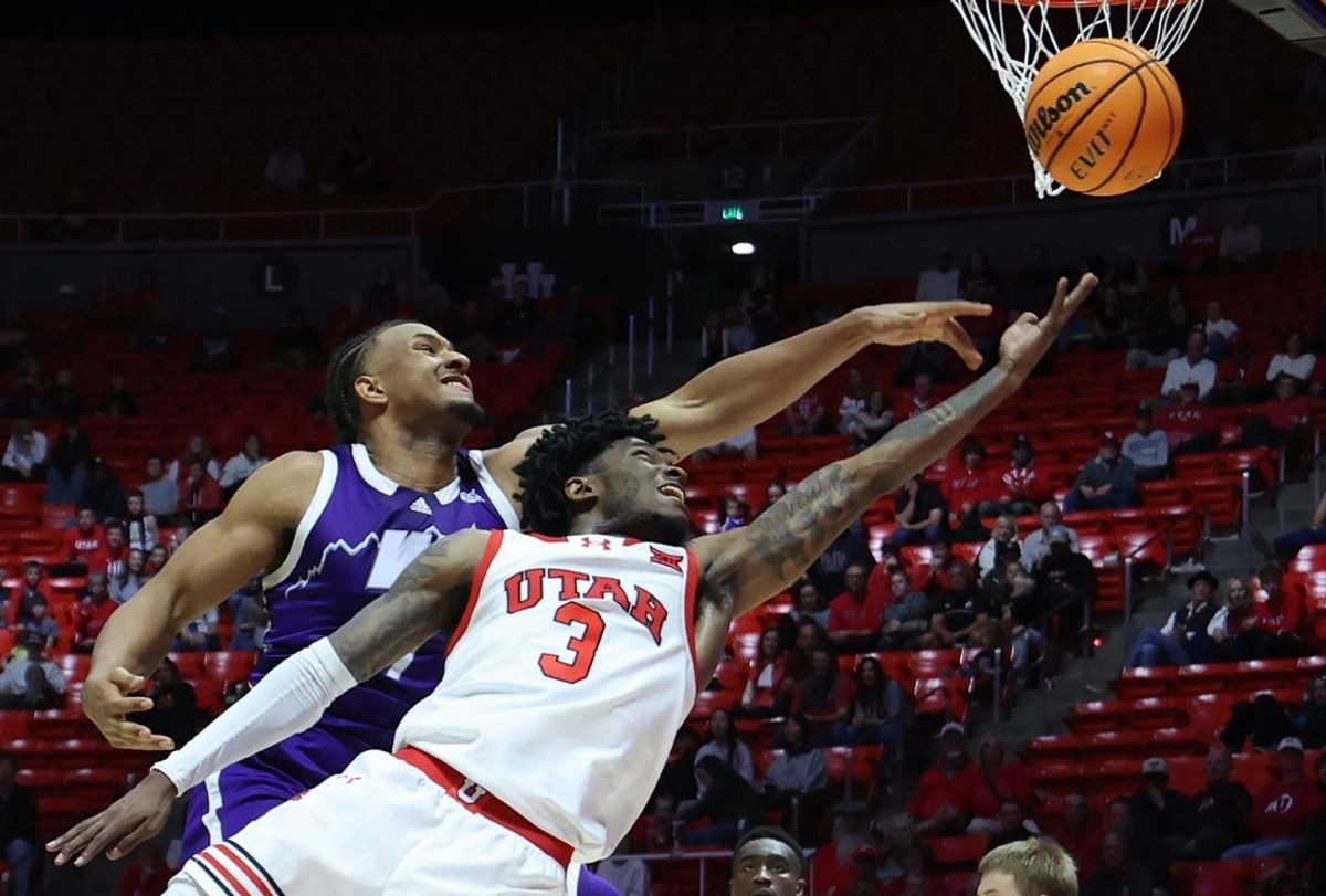 Nov 8, 2025; Salt Lake City, Utah, USA; Utah Utes guard Don McHenry (3) has a shot blocked by Weber State Wildcats center Malek Gomma (7) during overtime at Jon M. Huntsman Center. Mandatory Credit: Rob Gray-Imagn Images