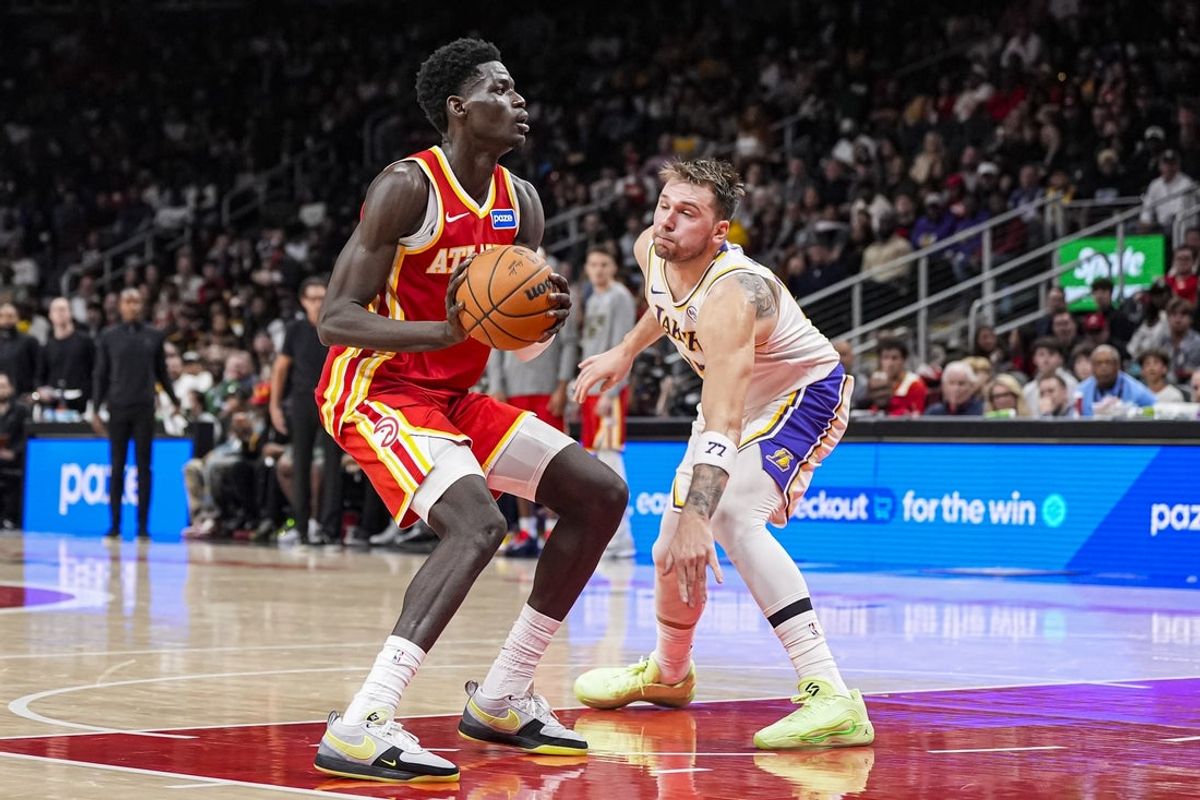 Nov 8, 2025; Atlanta, Georgia, USA; Atlanta Hawks forward Mouhamed Gueye (18) looks to shoot against Los Angeles Lakers guard Luka Doncic (77) during the second half at State Farm Arena. Mandatory Credit: Dale Zanine-Imagn Images