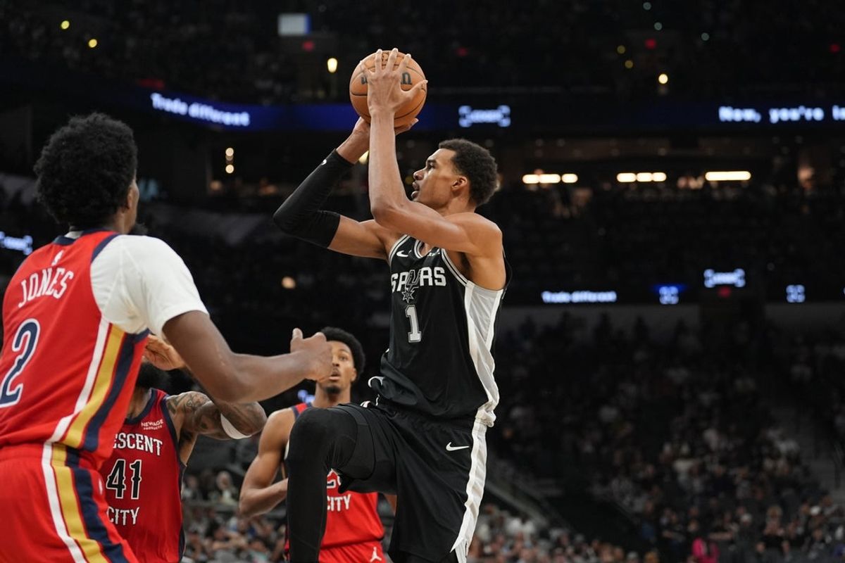 Nov 8, 2025; San Antonio, Texas, USA;  San Antonio Spurs forward Victor Wembanyama (1) shoots in front of New Orleans Pelicans forward Herbert Jones (2) in the second half at Frost Bank Center. Mandatory Credit: Daniel Dunn-Imagn Images