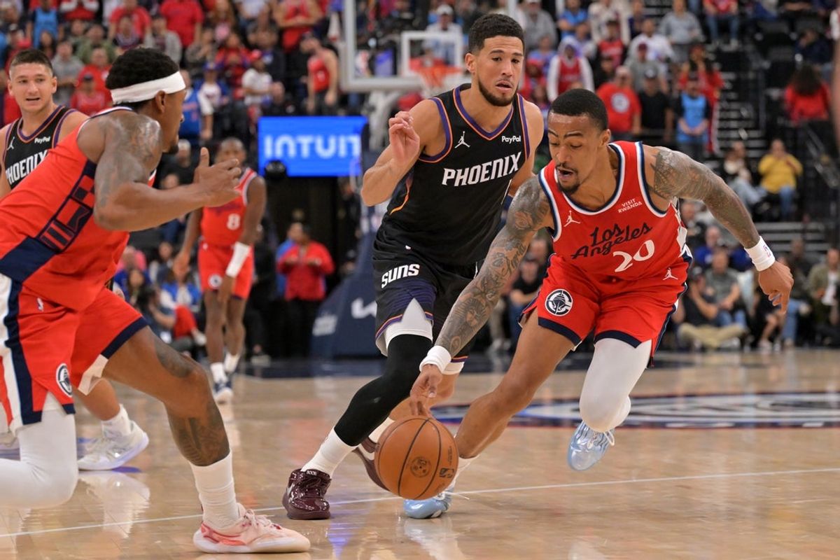 Nov 8, 2025; Inglewood, California, USA;  Los Angeles Clippers forward John Collins (20) steals the ball from Phoenix Suns guard Devin Booker (1) during the first half at Intuit Dome. Mandatory Credit: Jayne Kamin-Oncea-Imagn Images