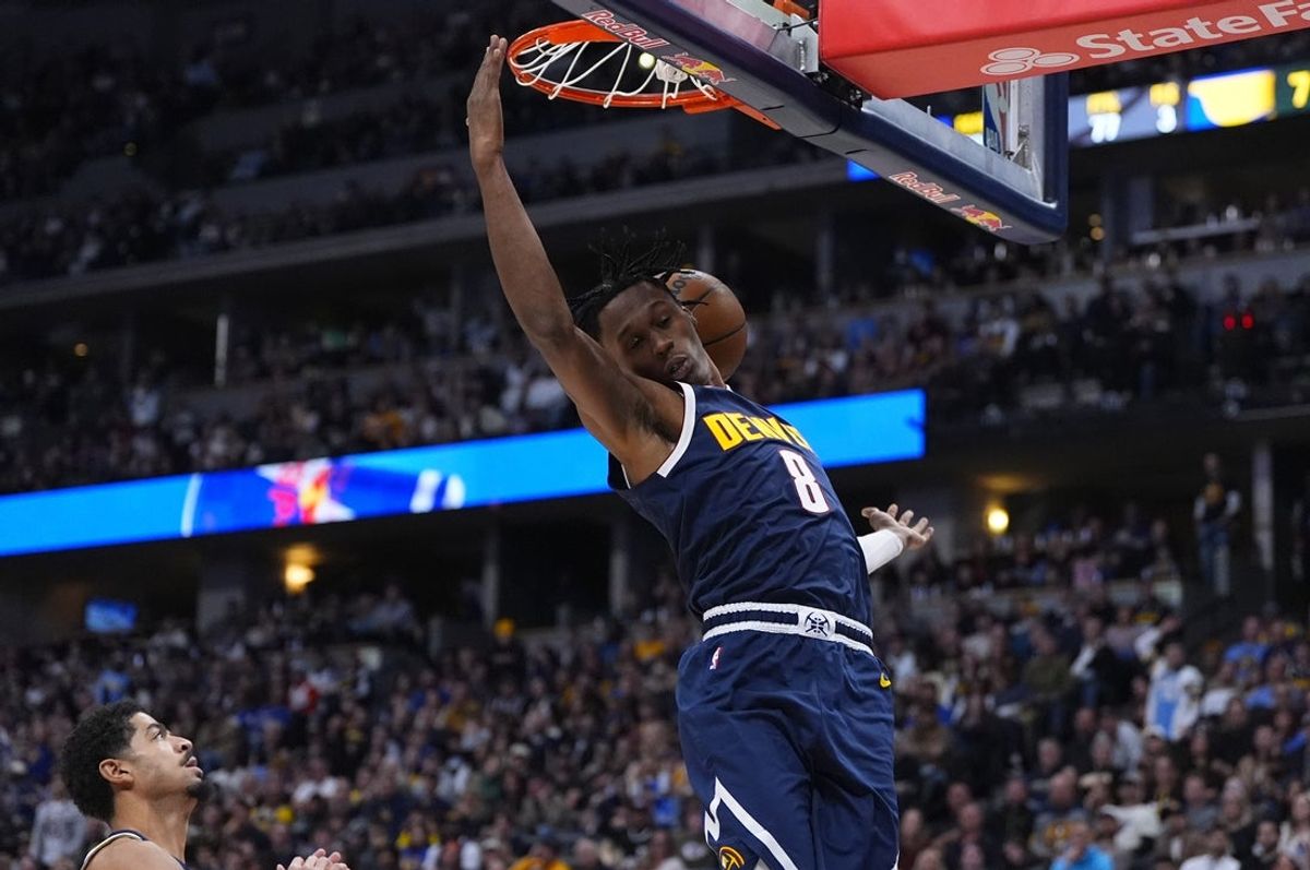 Nov 8, 2025; Denver, Colorado, USA; Denver Nuggets guard Peyton Watson (8) finishes off a basket in the second half against the Indiana Pacers at Ball Arena. Mandatory Credit: Ron Chenoy-Imagn Images