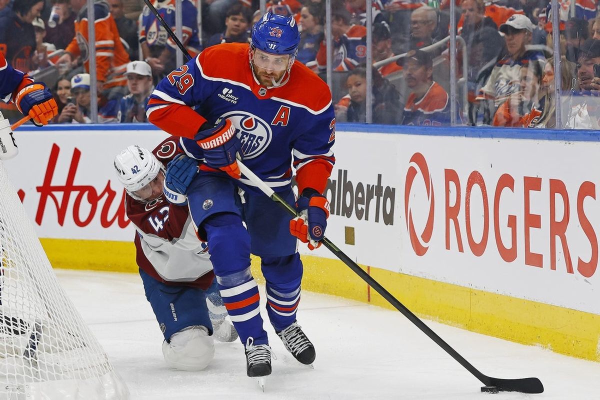 Nov 8, 2025; Edmonton, Alberta, CAN; Edmonton Oilers forward Leon Draisaitl (29) protects the puck from Colorado Avalanche defensemen Josh Manson (42) during the third period at Rogers Place. Mandatory Credit: Perry Nelson-Imagn Images