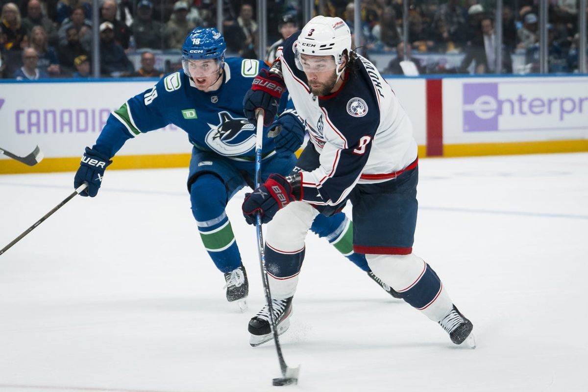 Nov 8, 2025; Vancouver, British Columbia, CAN; Vancouver Canucks forward Drew O'Connor (18) defends against Columbus Blue Jackets defenseman Ivan Provorov (9) in the third period at Rogers Arena. Mandatory Credit: Bob Frid-Imagn Images
