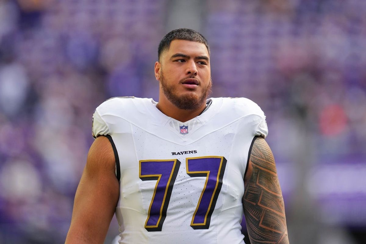 Nov 9, 2025; Minneapolis, Minnesota, USA; Baltimore Ravens guard Daniel Faalele (77) warms up before the game against the Minnesota Vikings at U.S. Bank Stadium. Mandatory Credit: Brad Rempel-Imagn Images