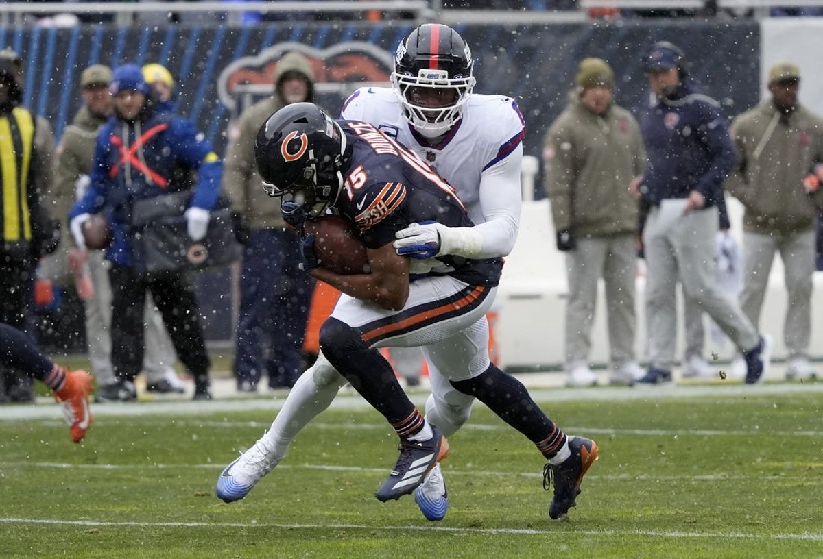 Nov 9, 2025; Chicago, Illinois, USA; New York Giants linebacker Brian Burns (0) tackles Chicago Bears wide receiver Rome Odunze (15) during the first half at Soldier Field. Mandatory Credit: David Banks-Imagn Images