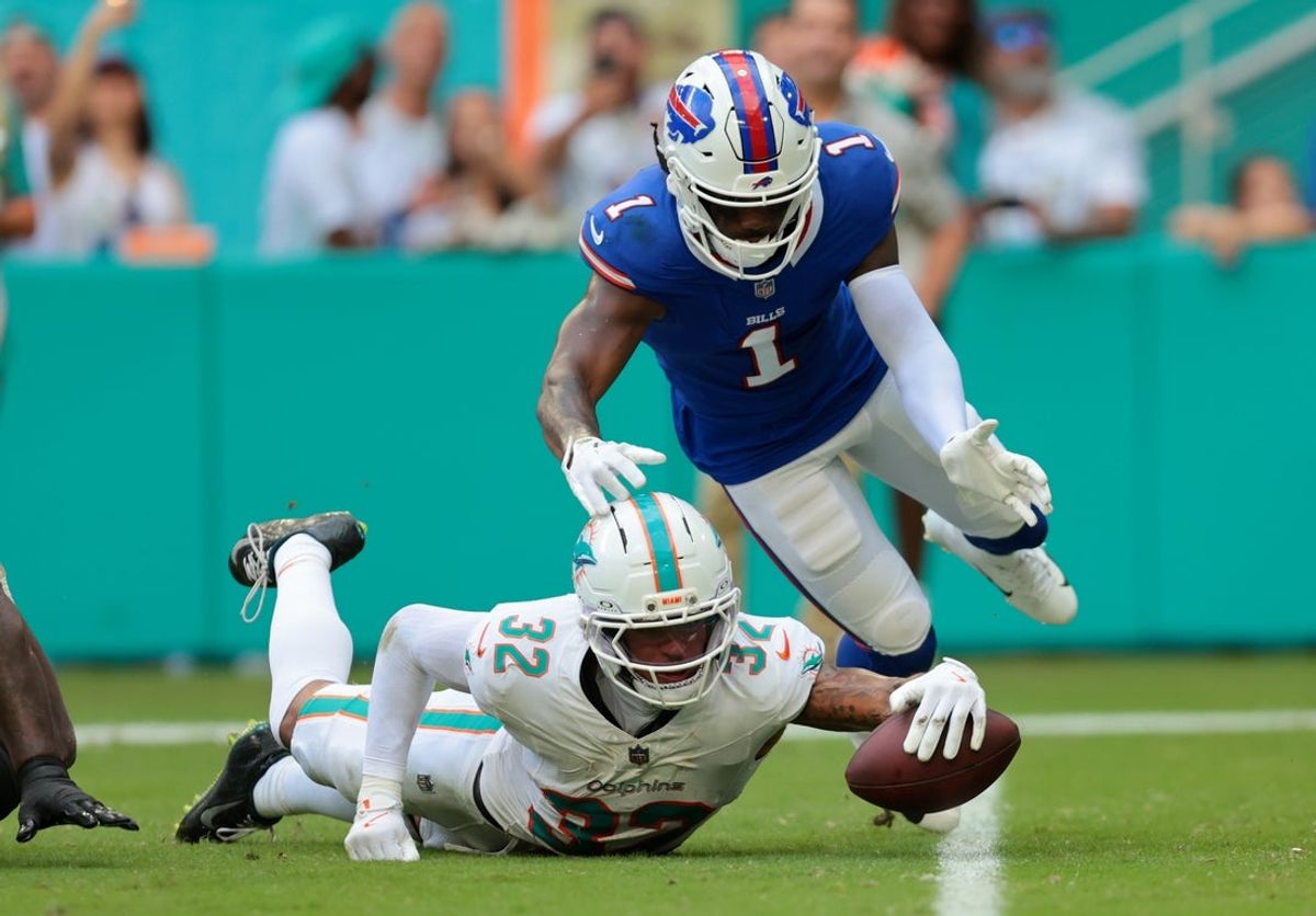 Nov 9, 2025; Miami Gardens, Florida, USA; Miami Dolphins cornerback JuJu Brents (32) recovers a fumble against Buffalo Bills wide receiver Curtis Samuel (1) during the first half at Hard Rock Stadium. Mandatory Credit: Sam Navarro-Imagn Images