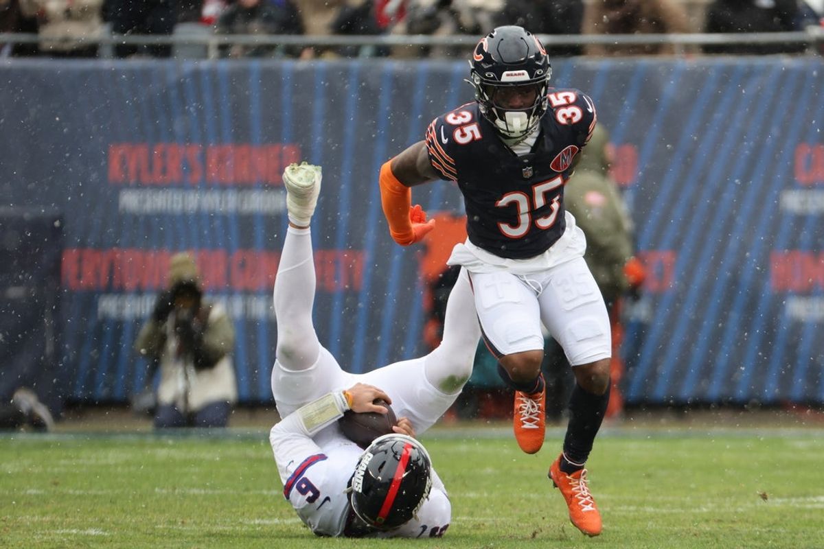 Nov 9, 2025; Chicago, Illinois, USA; Chicago Bears running back Deion Hankins (35) sacks New York Giants quarterback Jaxson Dart (6) during the first half at Soldier Field. Mandatory Credit: Mike Dinovo-Imagn Images