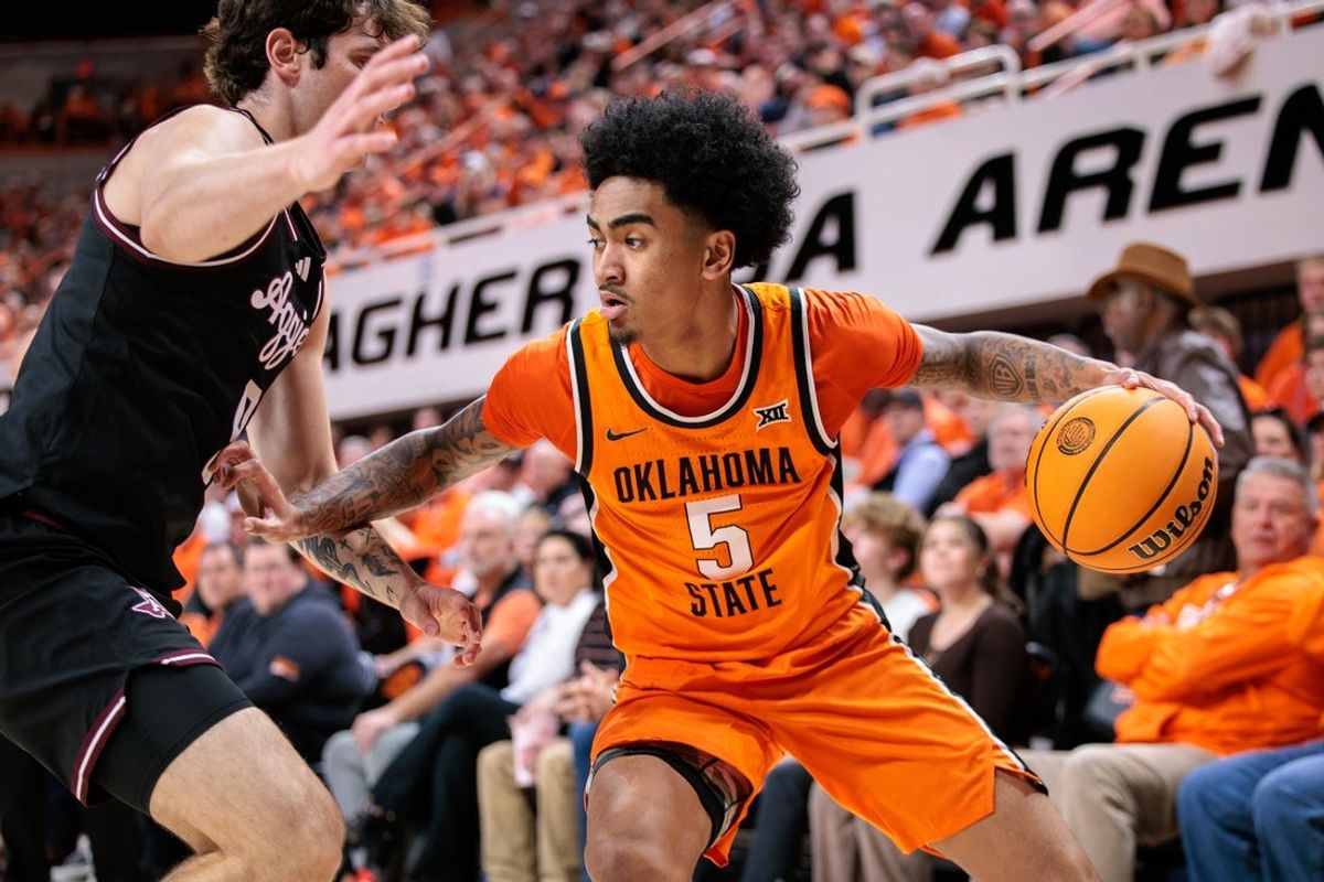 Nov 9, 2025; Stillwater, Oklahoma, USA; Oklahoma State Cowboys guard Vyctorius Miller (5) drives to the basket during the first half against the Texas A&M Aggies at Gallagher-Iba Arena. Mandatory Credit: William Purnell-Imagn Images