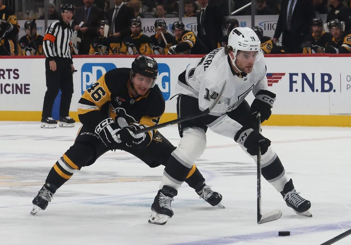 Nov 9, 2025; Pittsburgh, Pennsylvania, USA;  Los Angeles Kings right wing Alex Laferriere (14) skates with the puck against Pittsburgh Penguins center Blake Lizotte (46) during the second period at PPG Paints Arena. Mandatory Credit: Charles LeClaire-Imagn Images
