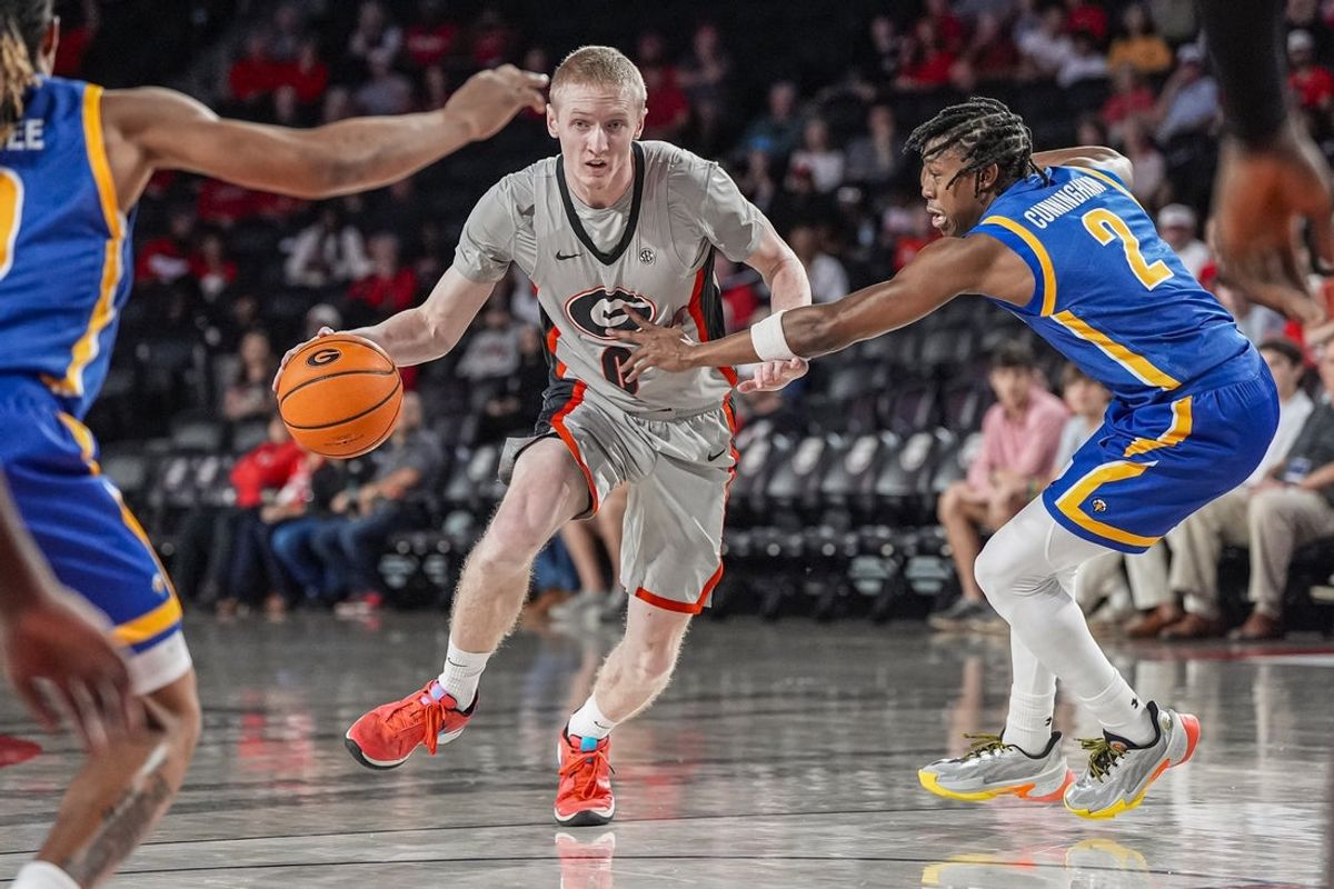 Nov 9, 2025; Athens, Georgia, USA; Georgia Bulldogs guard Blue Cain (0) dribbles past Morehead State Eagles guard Davion Cunningham (2) during the first half at Stegeman Coliseum. Mandatory Credit: Dale Zanine-Imagn Images